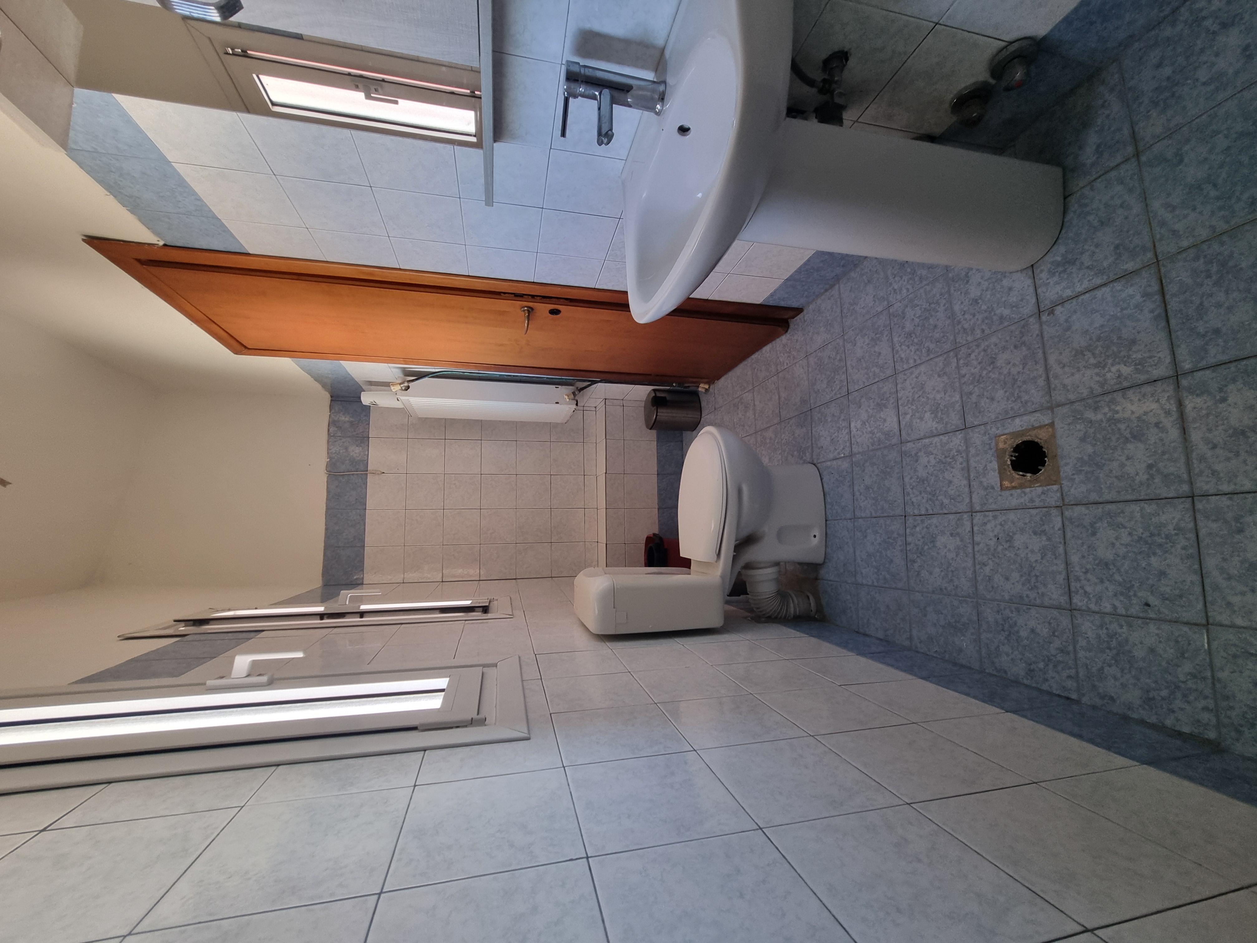 Polychrono Seabreeze Balcony Apartment bathroom with shower area, toilet, and sink