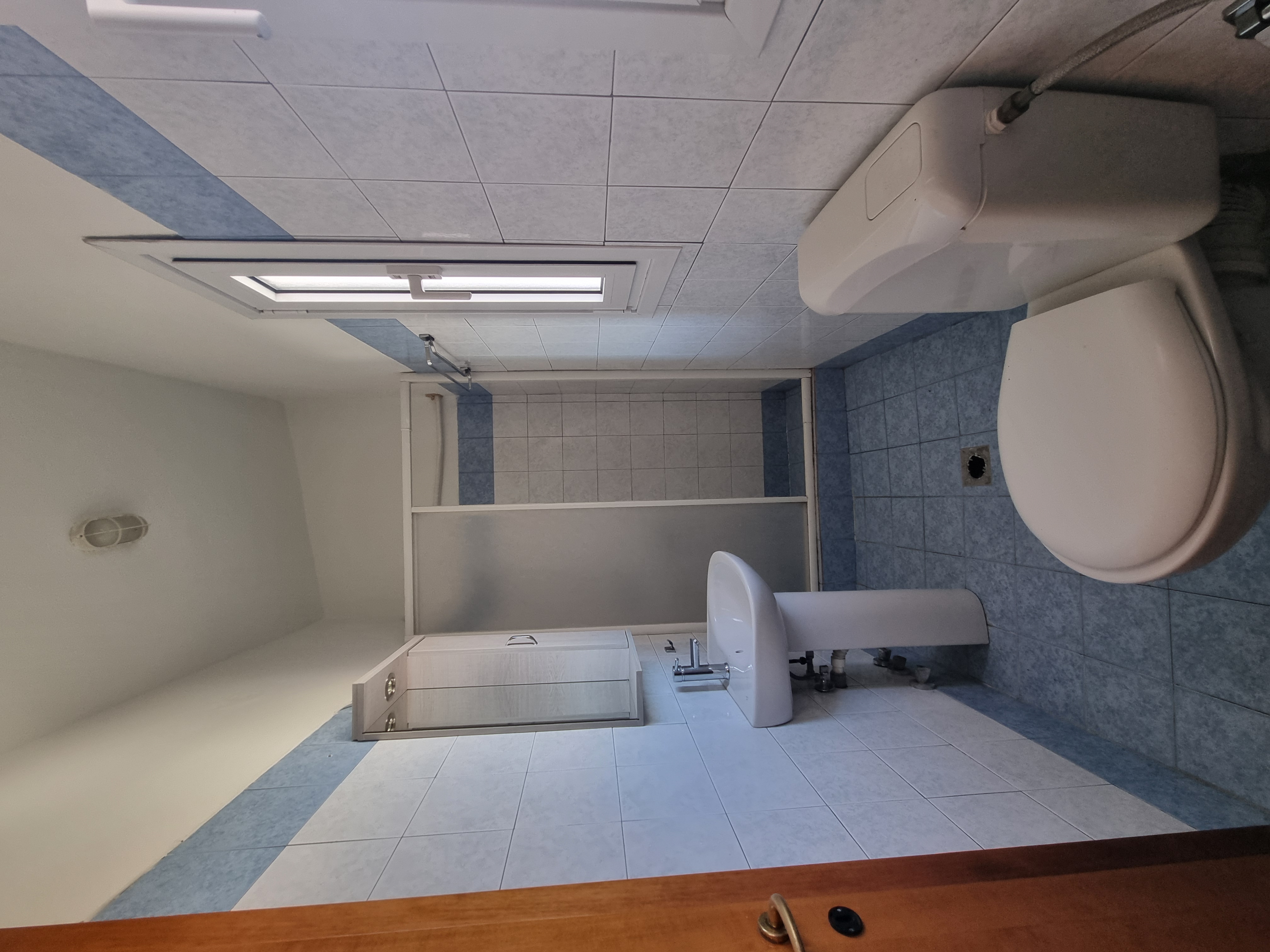 Polychrono Seabreeze Balcony Apartment bathroom with shower screen, vanity, and toilet