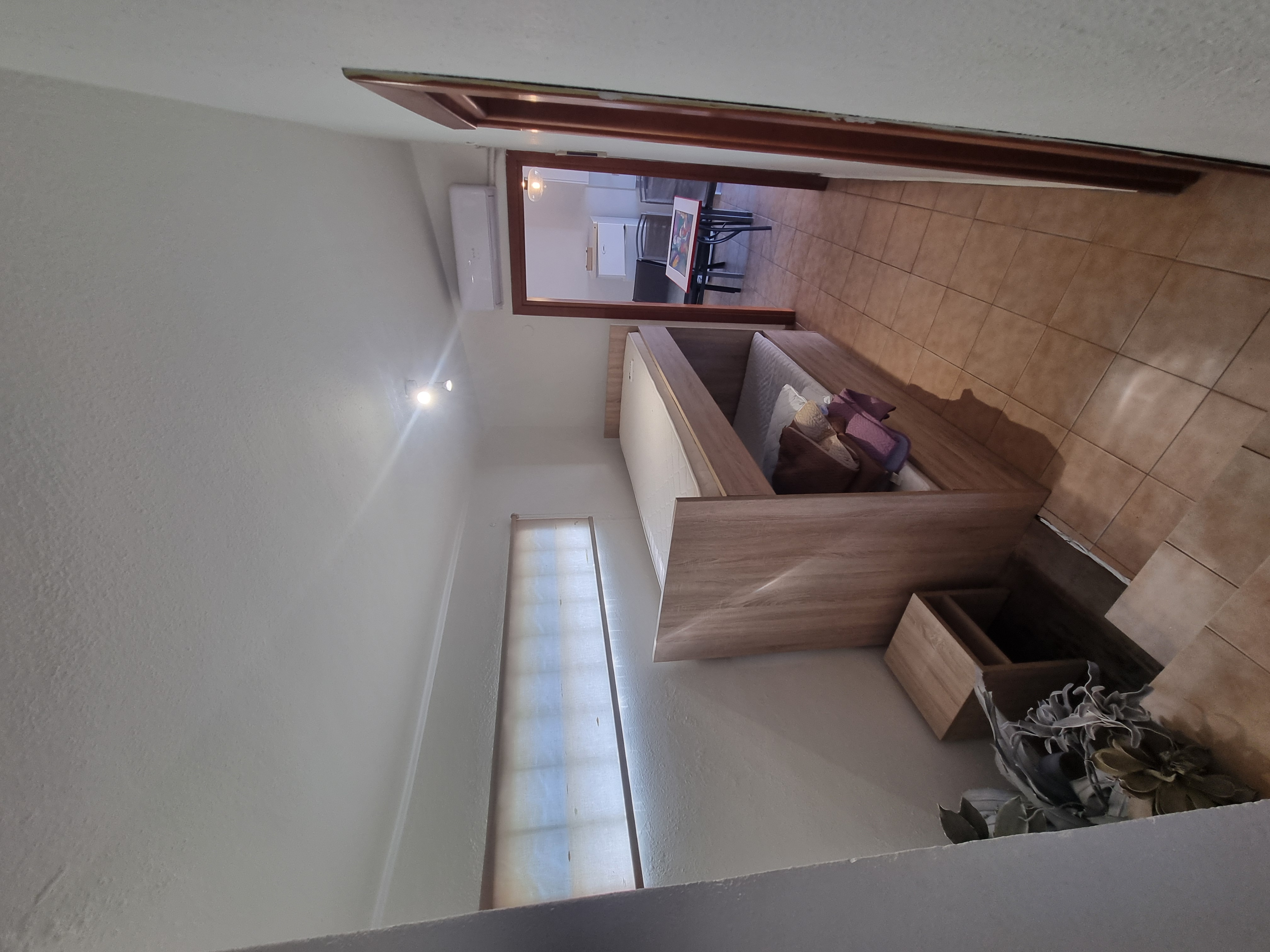 Polychrono Seabreeze Balcony Apartment bedroom with double bed and doorway toward the kitchen