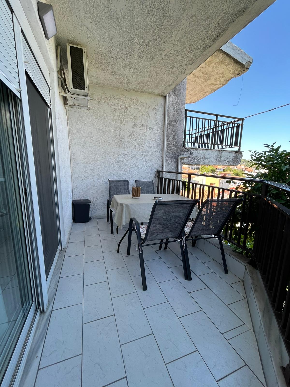 Aegean Dream balcony with outdoor dining table and chairs