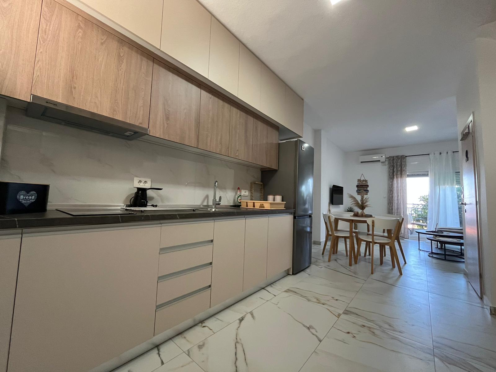 Aegean Dream kitchen with dining table and living room beyond