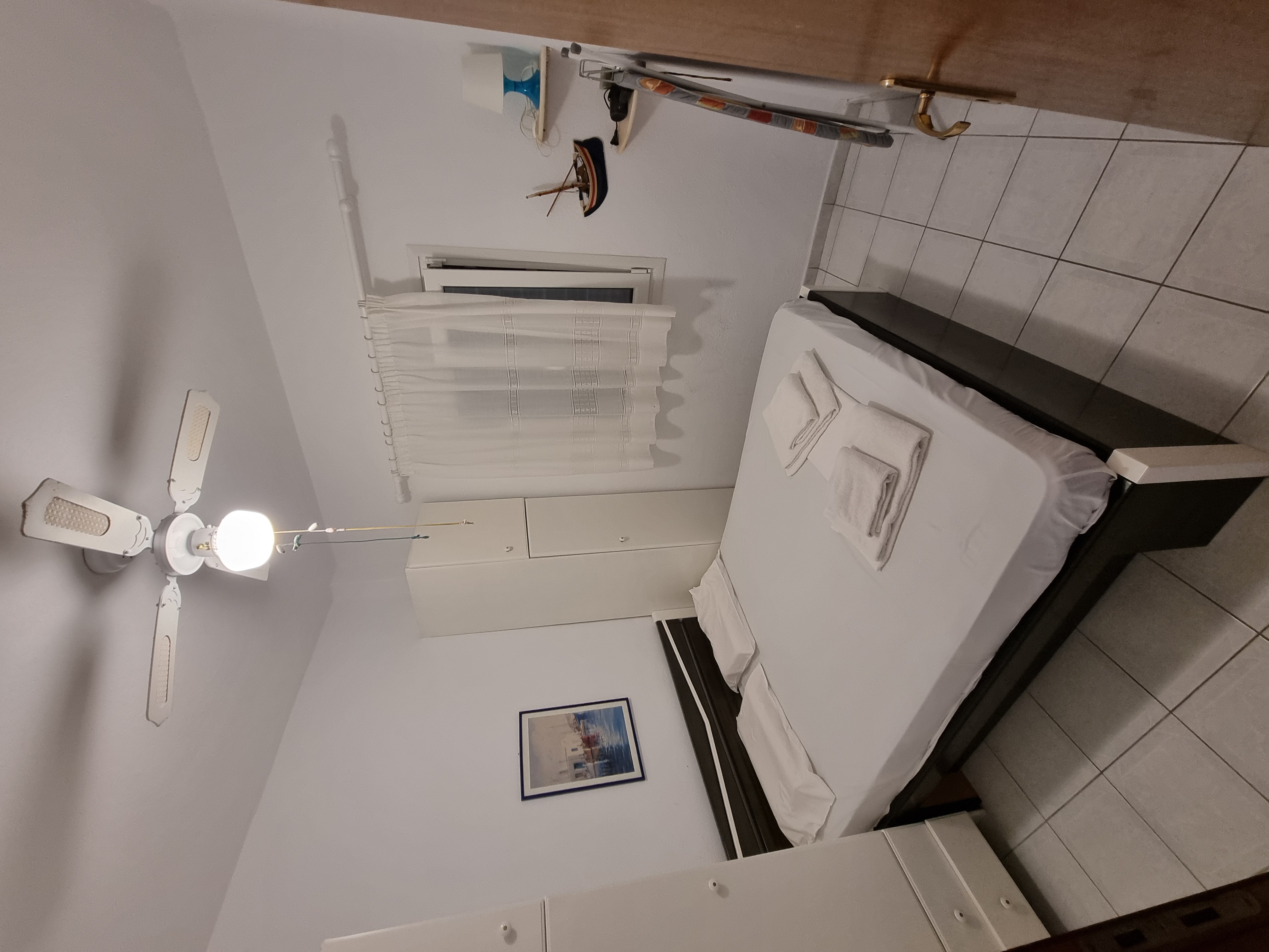 Polychrono Duplex bedroom with prepared bed and towels
